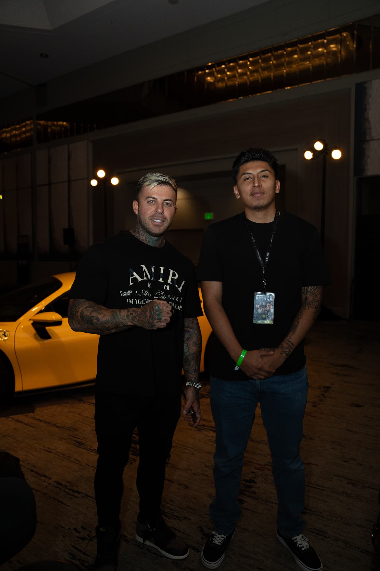 Louie Cannoy at an event beside a yellow sports car